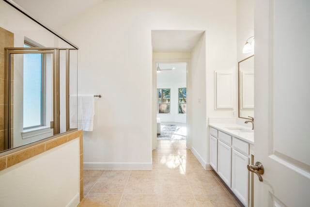 bathroom with tile patterned floors, walk in shower, and vanity