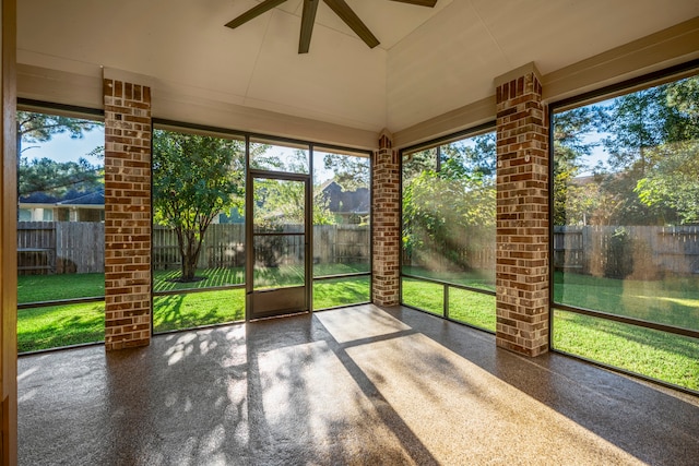 unfurnished sunroom with ceiling fan