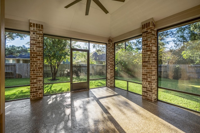 unfurnished sunroom with ceiling fan