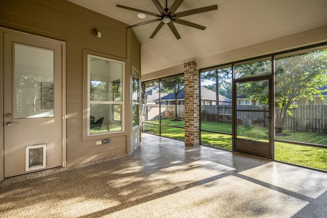 unfurnished sunroom featuring lofted ceiling and ceiling fan