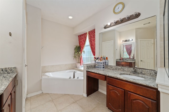 bathroom featuring tile patterned flooring, a bathing tub, and vanity