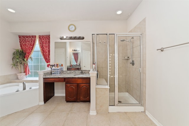 bathroom featuring vanity, shower with separate bathtub, and tile patterned floors