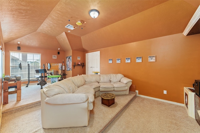 carpeted living room with a textured ceiling and lofted ceiling