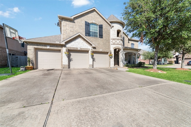 view of front of home featuring a garage and a front lawn