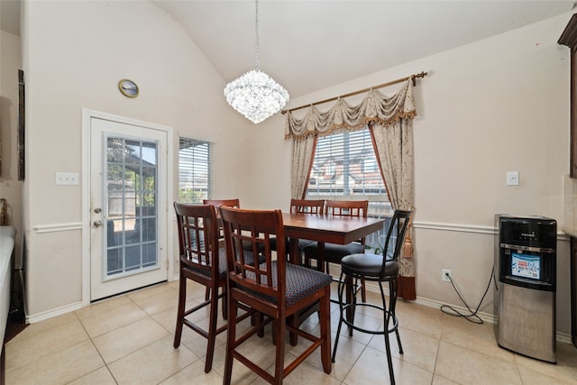 tiled dining room featuring a notable chandelier, plenty of natural light, and high vaulted ceiling