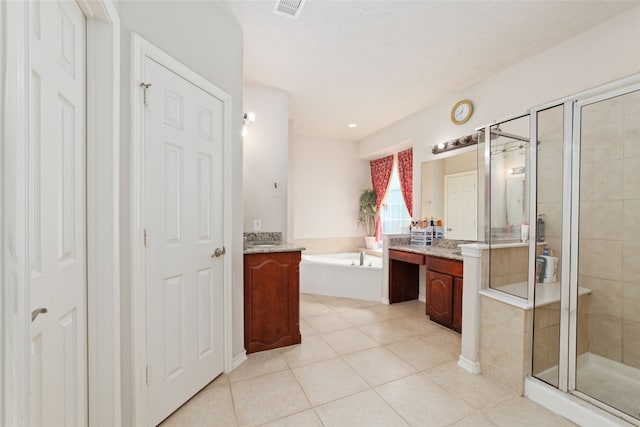 bathroom featuring shower with separate bathtub, tile patterned flooring, and vanity