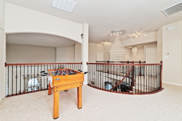 playroom featuring carpet floors and a chandelier