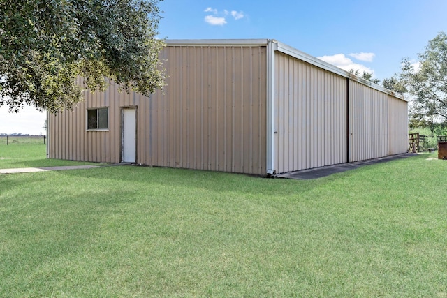 view of outbuilding featuring a yard