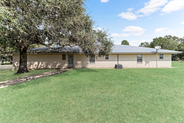 back of property featuring a yard and cooling unit