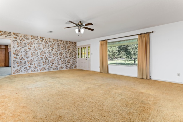 spare room with carpet flooring and ceiling fan