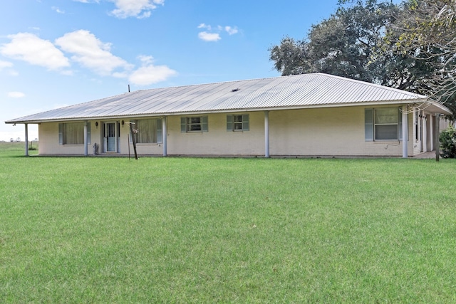 3030 Moore Rd, Beaumont, TX 77713 - back of house featuring metal roof, brick siding, a porch, and a lawn