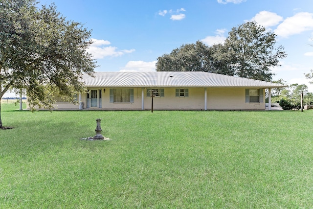 rear view of property with a lawn