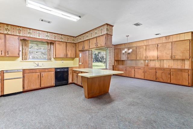 kitchen with light colored carpet, sink, a notable chandelier, dishwasher, and hanging light fixtures