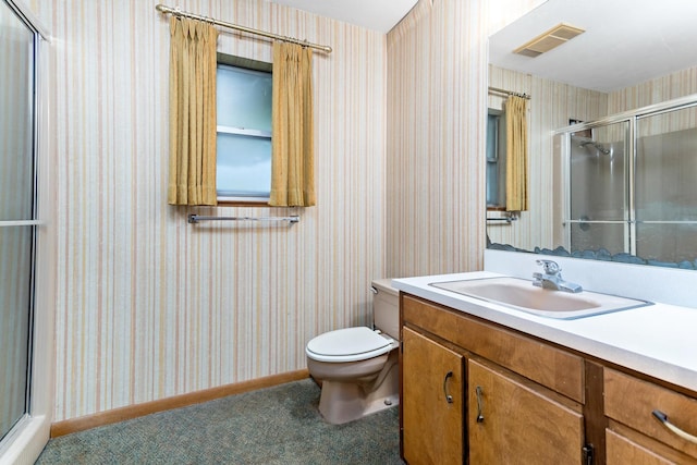 bathroom featuring vanity, toilet, and walk in shower