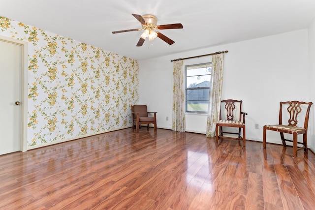 sitting room with ceiling fan and dark hardwood / wood-style flooring