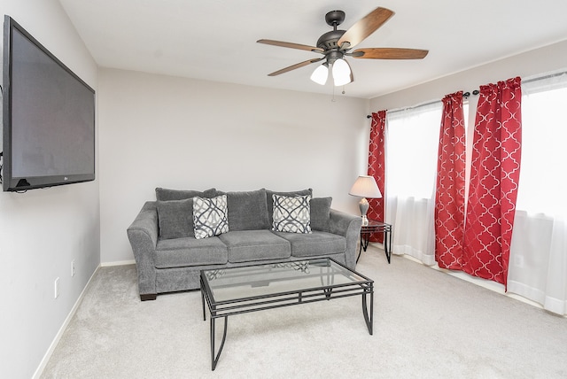 carpeted living room with ceiling fan