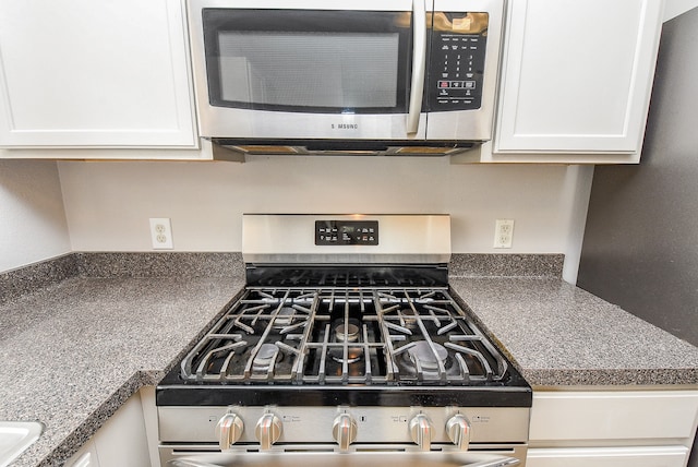 details featuring white cabinets and appliances with stainless steel finishes