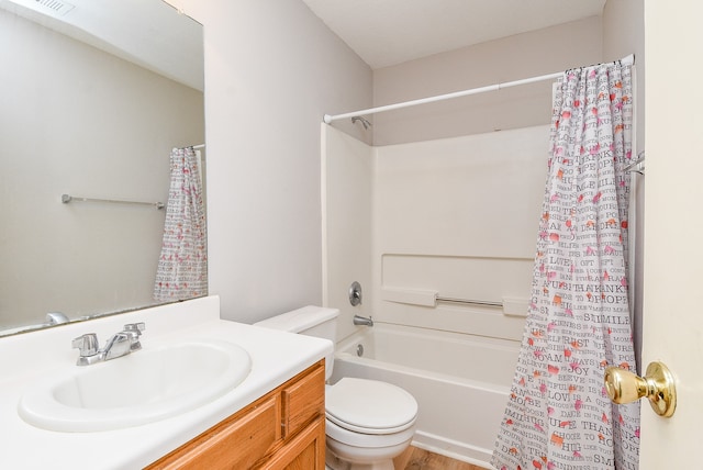 full bathroom with hardwood / wood-style floors, vanity, shower / tub combo, and toilet