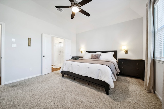 carpeted bedroom featuring ceiling fan and ensuite bath