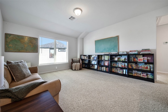 sitting room with light colored carpet and lofted ceiling