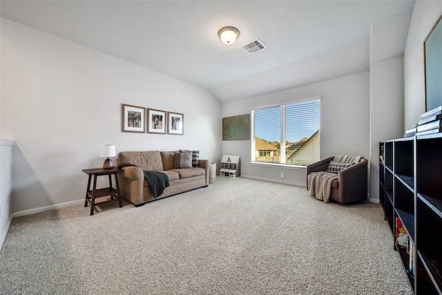 living room with lofted ceiling and carpet flooring