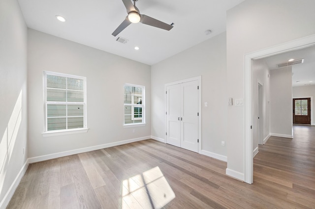 unfurnished bedroom featuring ceiling fan, light hardwood / wood-style flooring, and a closet