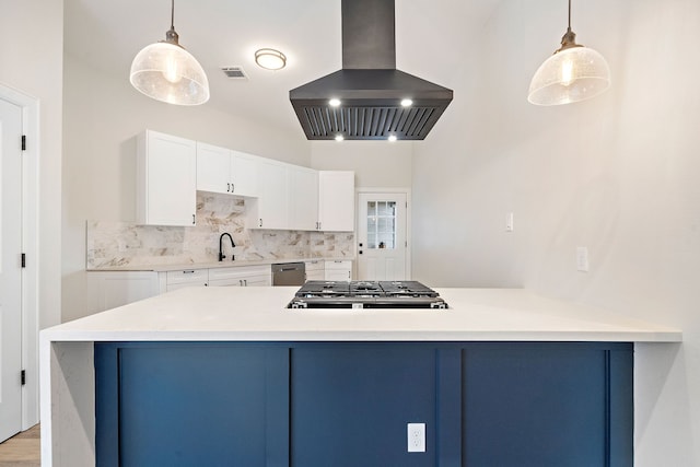 kitchen featuring island exhaust hood, white cabinets, and decorative light fixtures