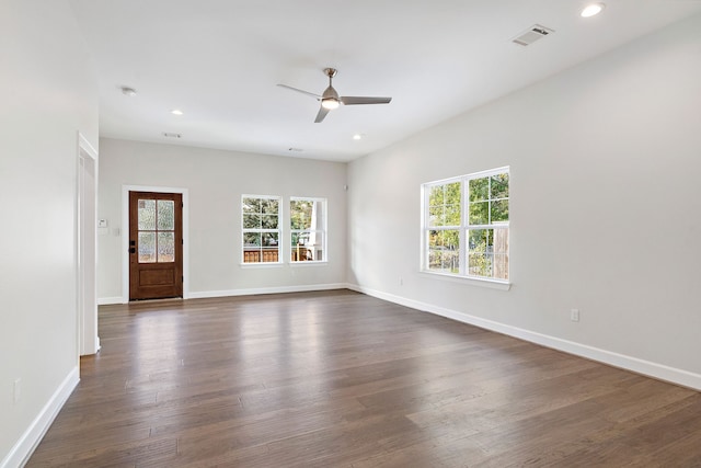 empty room featuring dark hardwood / wood-style flooring and ceiling fan