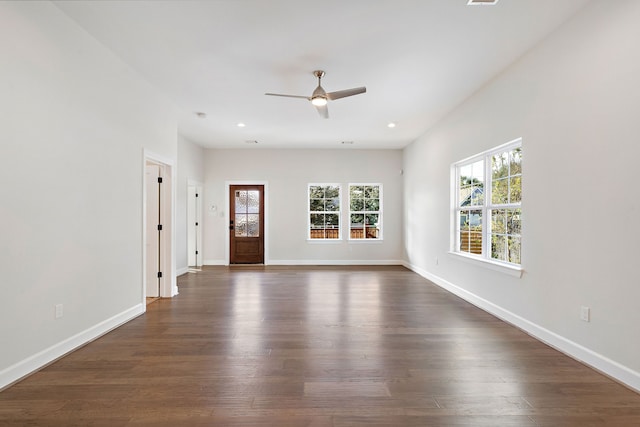 empty room featuring ceiling fan and dark wood-type flooring