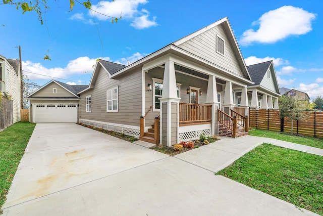 view of front facade with a garage, a front yard, and covered porch