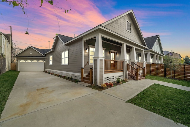 view of front of house with a garage, an outbuilding, a porch, and a yard