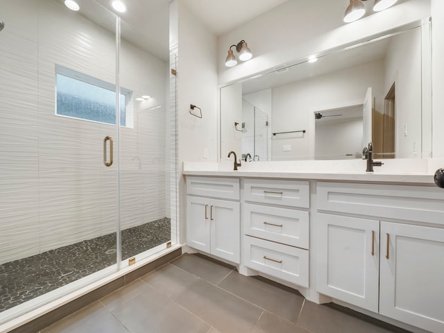 bathroom featuring vanity, a shower with door, and tile patterned floors