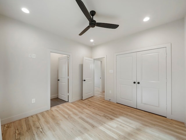 unfurnished bedroom with ceiling fan, a closet, and light hardwood / wood-style floors