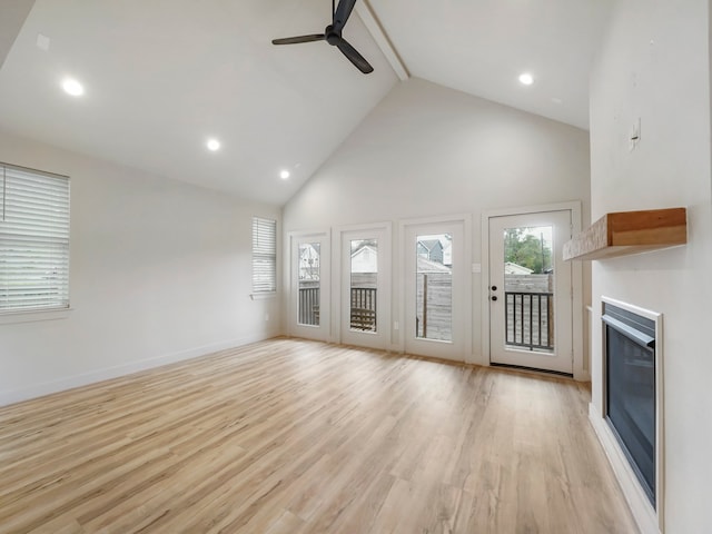 unfurnished living room with ceiling fan, beamed ceiling, light wood-type flooring, and high vaulted ceiling