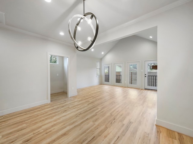 unfurnished living room with a notable chandelier, light hardwood / wood-style flooring, ornamental molding, and lofted ceiling