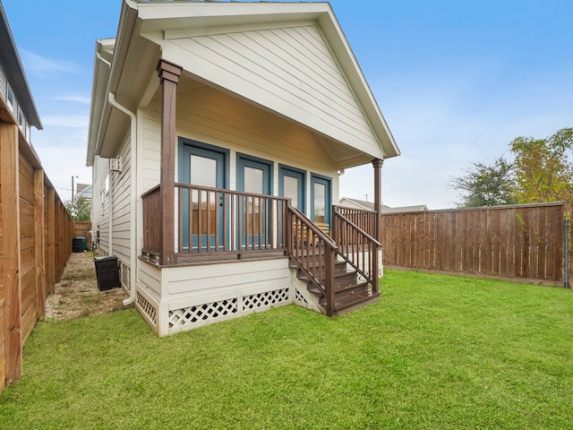 rear view of house featuring a yard