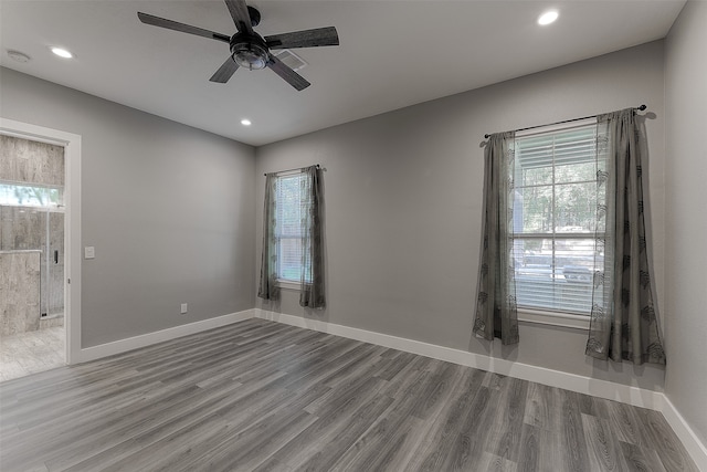 unfurnished room with ceiling fan, plenty of natural light, and hardwood / wood-style floors