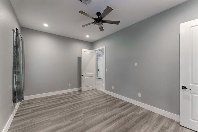 unfurnished bedroom with ceiling fan and light hardwood / wood-style flooring