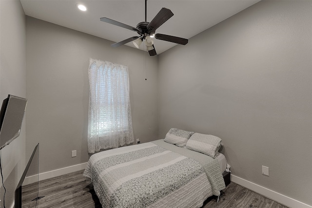 bedroom with ceiling fan and dark hardwood / wood-style floors