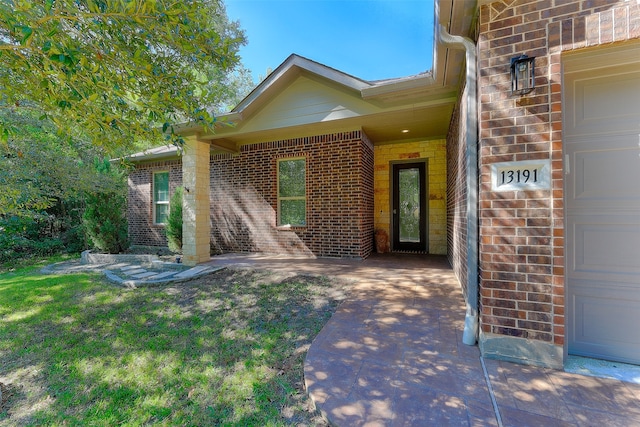 doorway to property featuring a yard