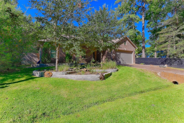 view of front of property featuring a front yard and a garage