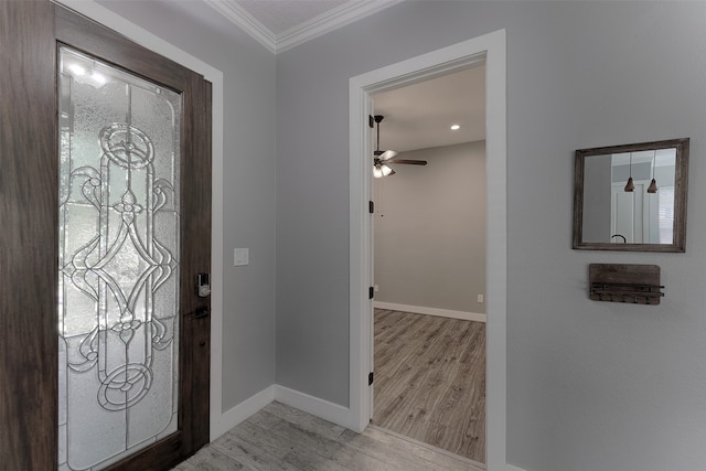 foyer entrance with light wood-type flooring, crown molding, and ceiling fan