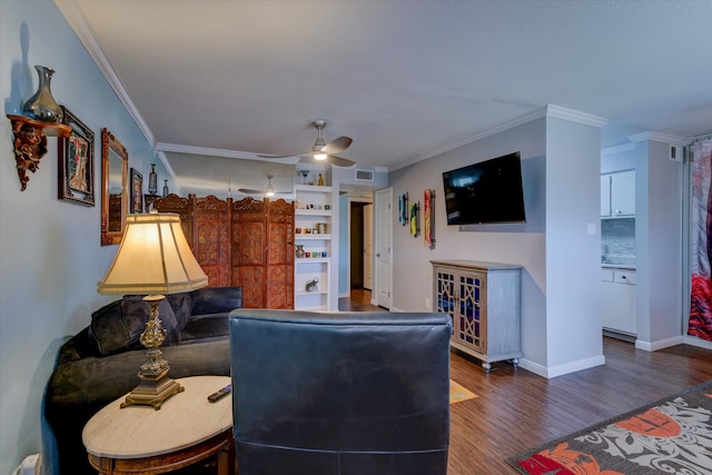 living room with ceiling fan, built in features, ornamental molding, and dark wood-type flooring