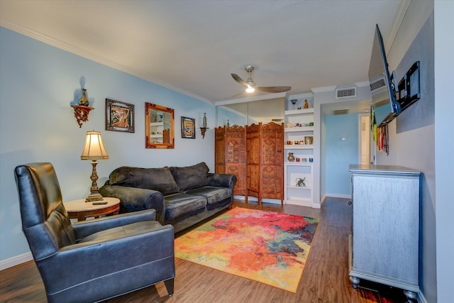 living room with ceiling fan, crown molding, and dark wood-type flooring