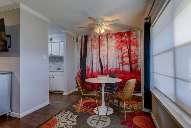 dining area with ceiling fan, sink, dark wood-type flooring, and ornamental molding