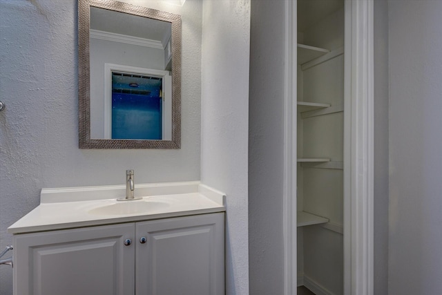 bathroom with vanity and ornamental molding