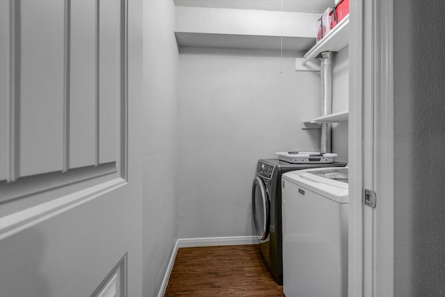 washroom with dark hardwood / wood-style floors and washing machine and clothes dryer