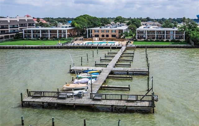 view of dock featuring a swimming pool and a water view