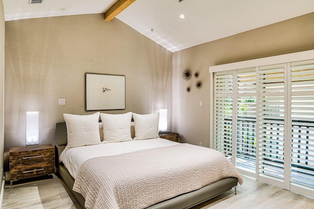 bedroom featuring vaulted ceiling with beams and light hardwood / wood-style flooring