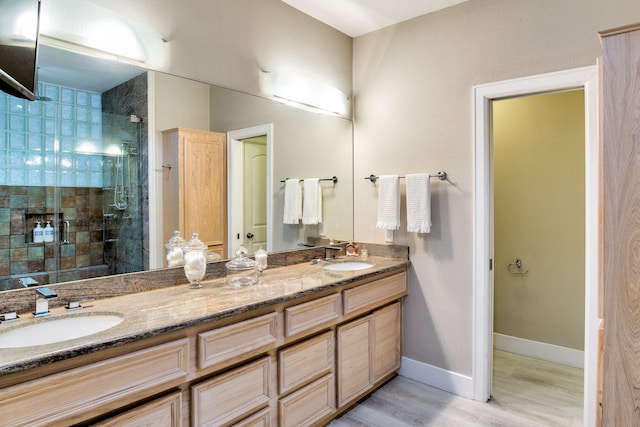 bathroom with vanity, hardwood / wood-style floors, and a shower with door